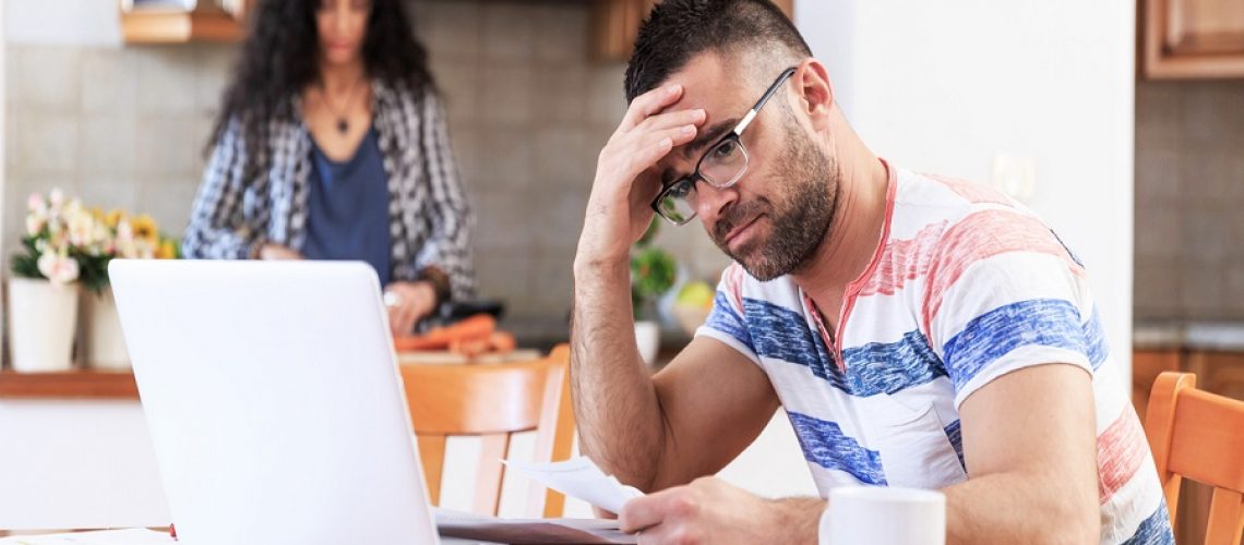 Couple doing home budgeting, using laptop, having problems.
