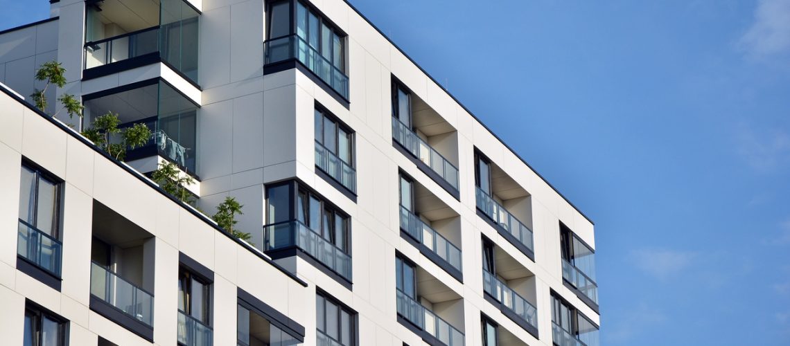 Modern apartment buildings on a sunny day with a blue sky.